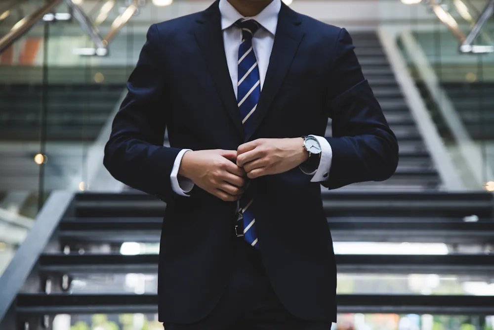 buisiness man buttoning up suit