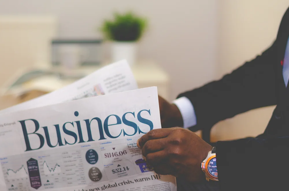 Businasman reading daily paper with Business headline
