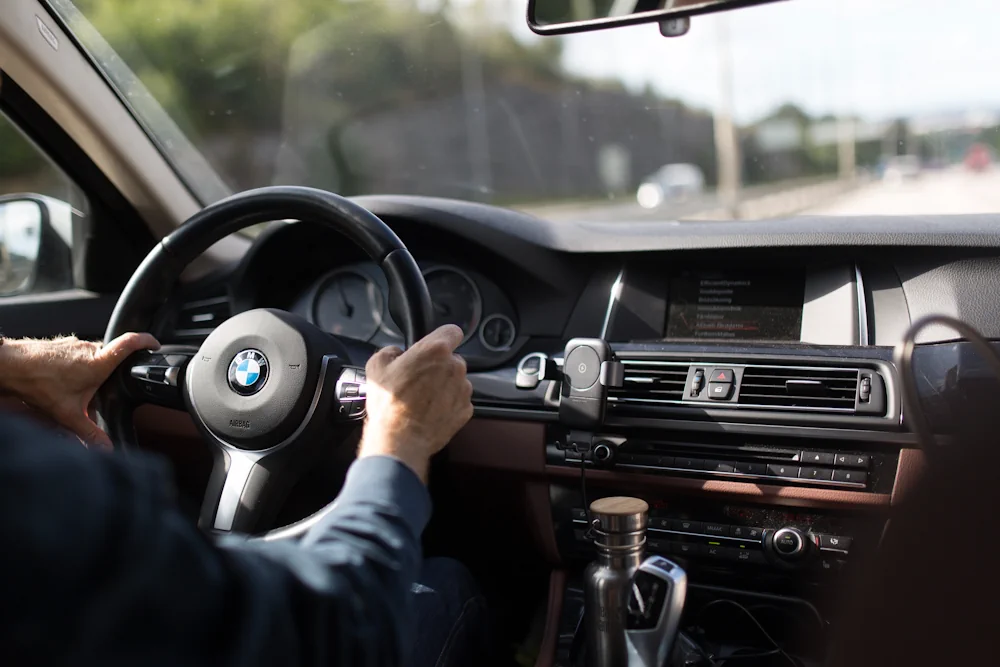 Inside of chauffeur driven BMW from backseat to front