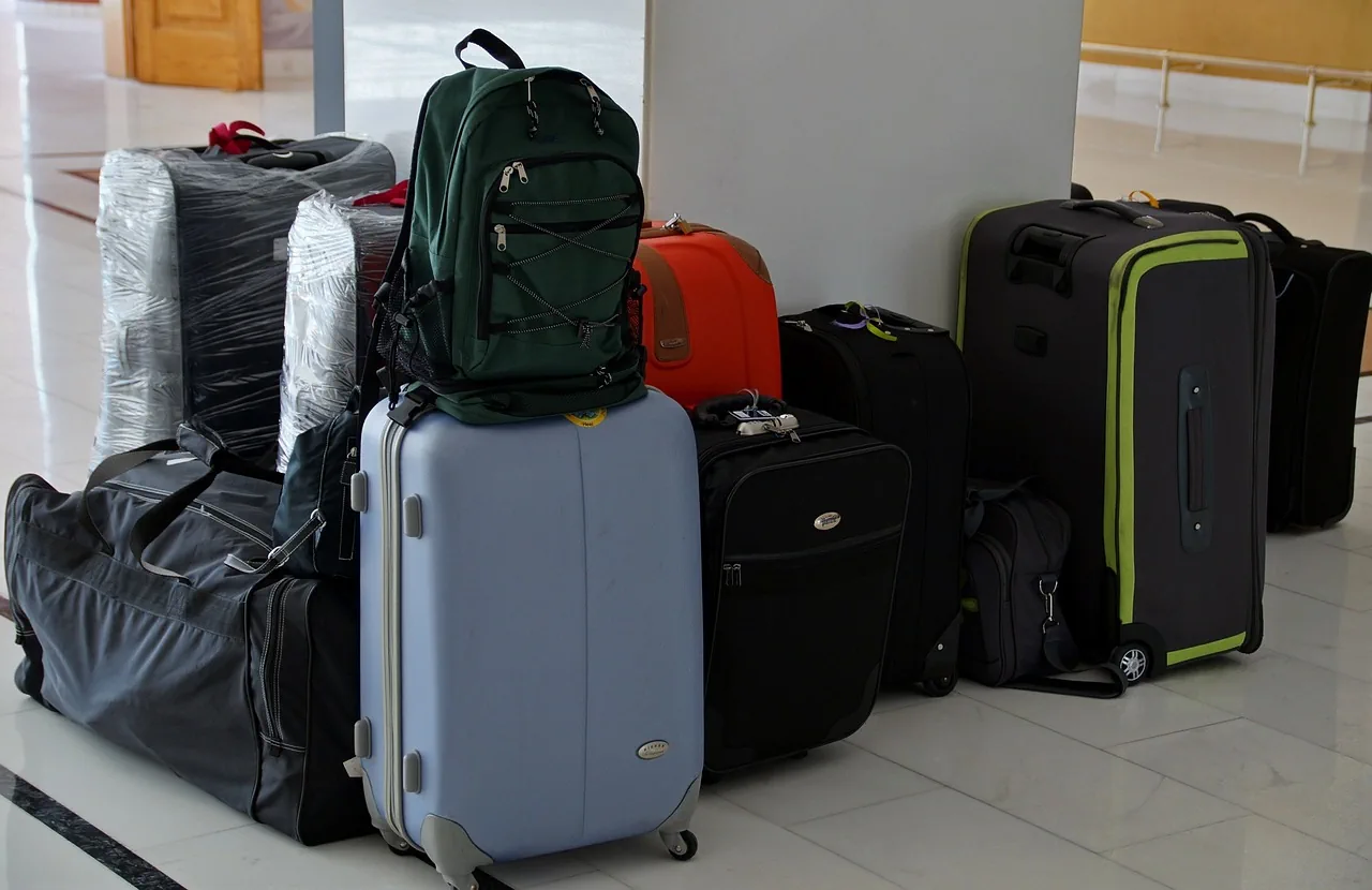 Large amount of luggage stacked.